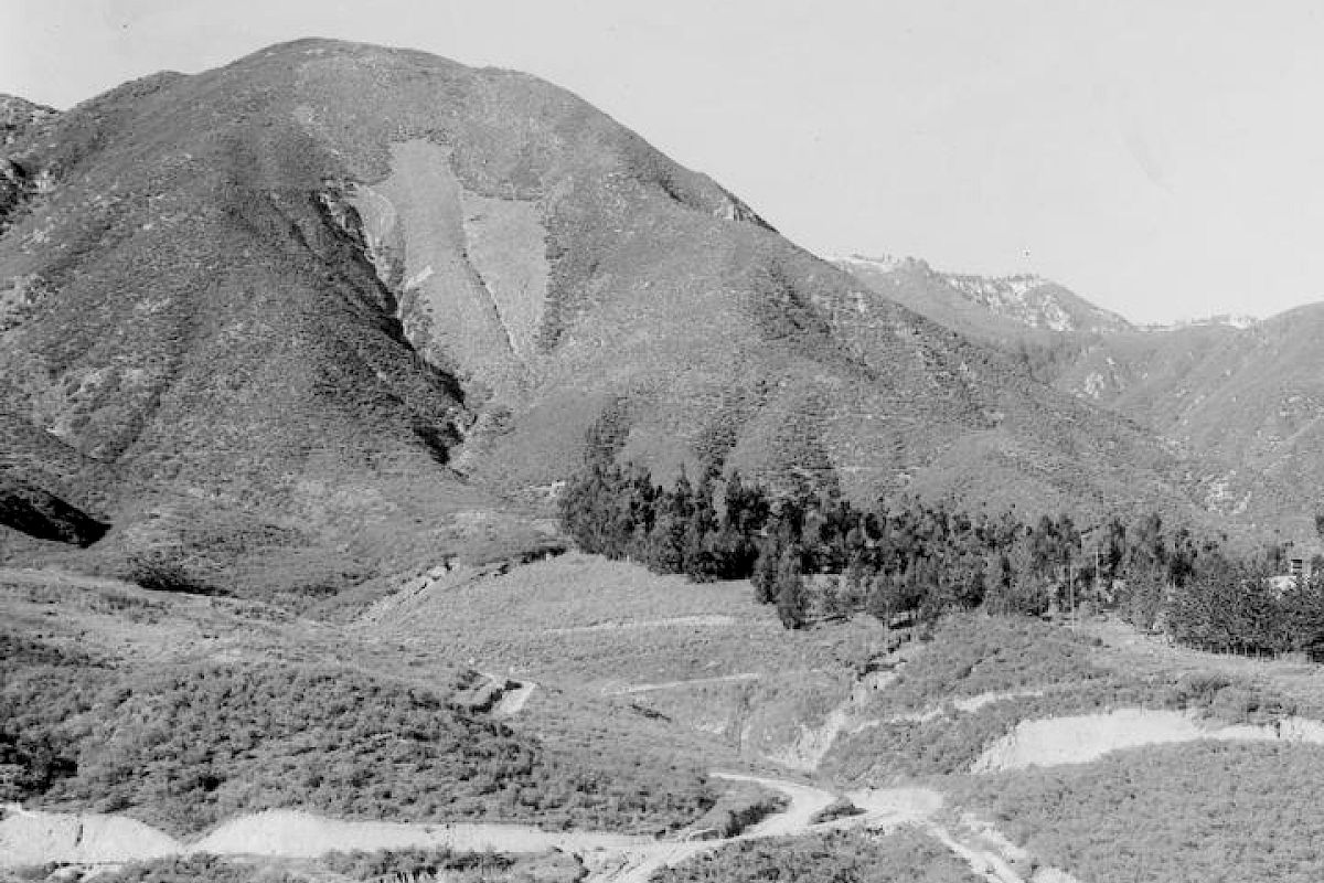 It's a black and white photo showing a mountainous landscape with dense vegetation.