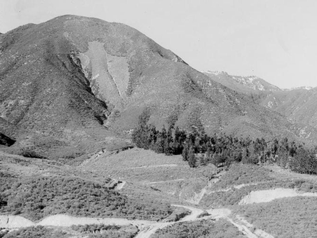 It's a black and white photo showing a mountainous landscape with dense vegetation.