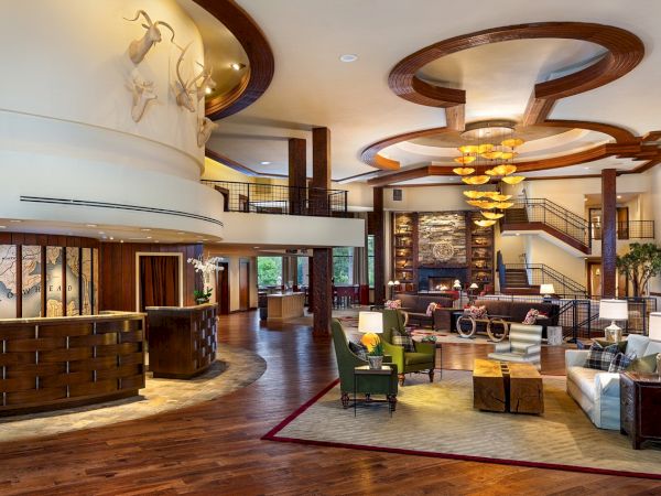 Elegant hotel lobby with modern decor, comfy seating, artistic lighting, and a warm ambiance.