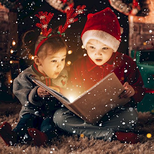 Two kids sit by a fireplace in festive hats, glowing from a shared book as snow falls around a cozy Christmas scene.