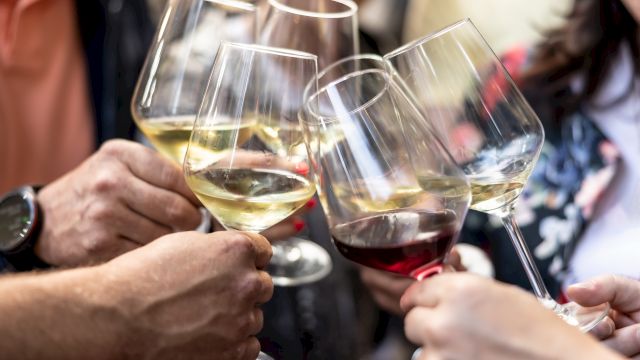 A group toasting with wine glasses, clinking in celebration. Cheers to friendship and moments shared together.